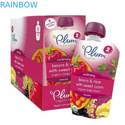 Individu tenant les sachets en matière plastique empaquetant des poches d'aliment pour bébé d'emballage de yaourt de poches de bec